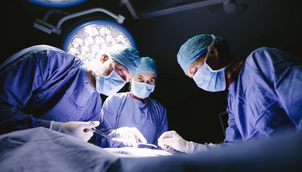 Surgeons replacing a heart valve